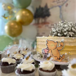 Portrait mode of cake with cupcakes from bakery.