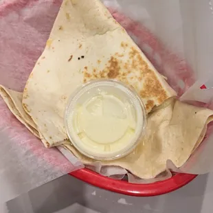 cheese and salsa quesadilla with a side of queso