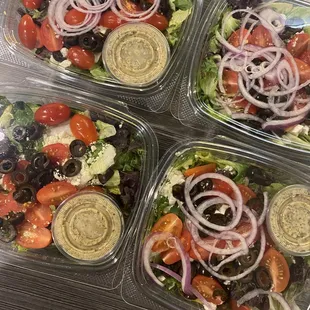 four containers of salads