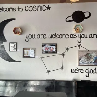 a mural of the moon, the sun, and the stars