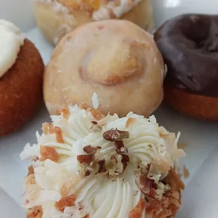 a variety of doughnuts on a white plate