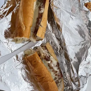 two sandwiches on tin foil