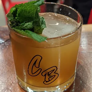 a drink in a glass on a table