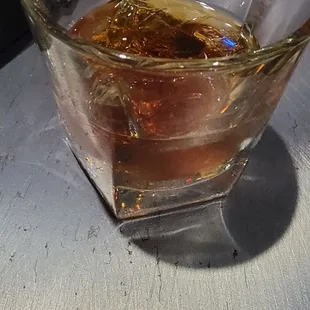 a glass of whiskey on a table