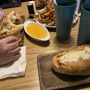 Steak hoagies with house made peppers. Handcut fries and cheese dipping sauce.