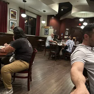 people sitting at tables and eating