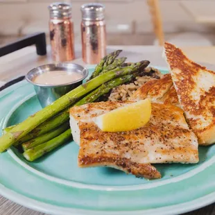 a plate of fish and asparagus