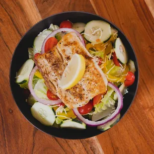 a bowl of fish and vegetables