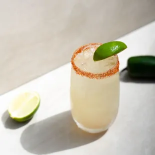 a margarita with a lime garnish on the rim