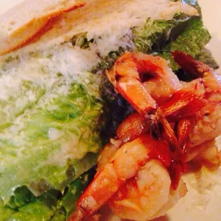 a plate of food with shrimp and lettuce