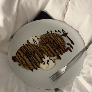 a plate of food on a bed