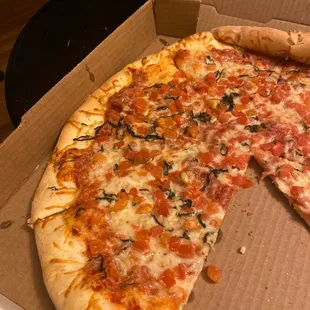 a half eaten pizza in a box