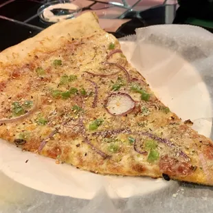 a slice of pizza on a paper plate