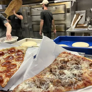 Pepperoni and sausage slices at the counter.