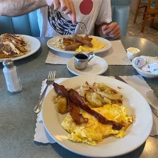 a man sitting at a table eating breakfast