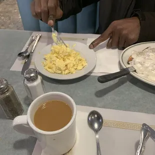 a plate of food and a cup of coffee