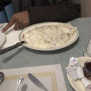 a man sitting at a table with a plate of food