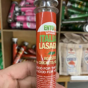 a hand holding a bottle of ketchup