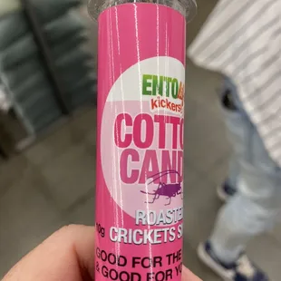 a person holding a bottle of cotton candy