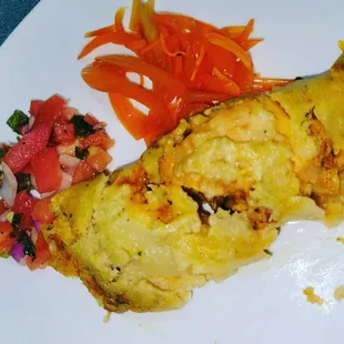 a plate of food with a side of vegetables