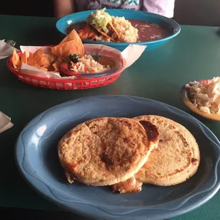 2 pupsas Bombas style! It has cheese, pork, and beans. Yum! Friend ordered beef taco &amp; chicken enchilada with rice and beans.