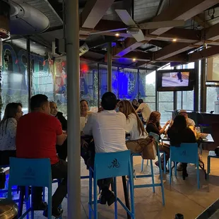 a group of people sitting at tables in a restaurant