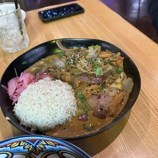 Pescado saltado with Mahi Mahi, onions, tomatoes and jasmine rice. Pickled red onions as well.