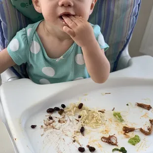 Baby eating costa Vida sweet pork salad