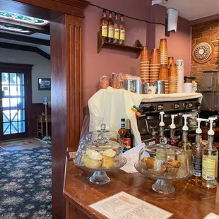 a coffee shop counter with pastries on it