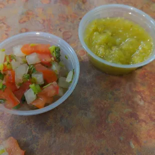Salsa bar with salsas,  pico, cucumber, jalapeno, cilantro, onions, and limes