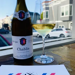 a glass of wine and menu