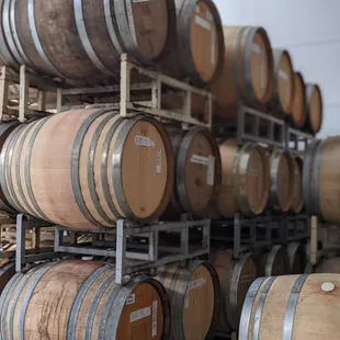 rows of wine barrels in a cellar