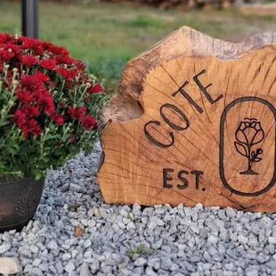 a wooden sign and a potted plant