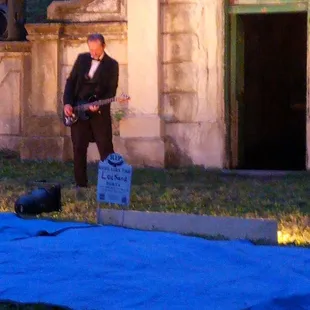 Guitarist well dressed and dishing out Poe riffs.