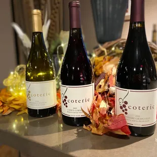 three bottles of wine on a counter