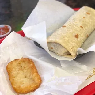 Machaca burrito and one sorry looking hash brown.