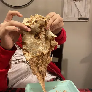 a child eating a tortilla