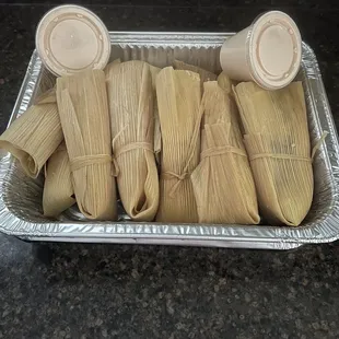Delicious beef and pork tamales with seasoned sour cream.