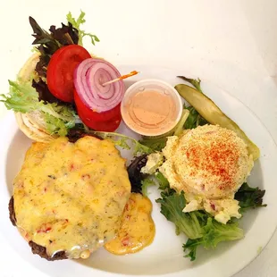 a white plate with a sandwich and salad