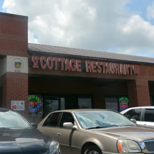 cars parked in front of a restaurant