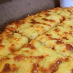 Delicious Garlic Cheese Bread Comes with pizza sauce and a Garlic Butter cup!