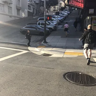 a man walking across a city street
