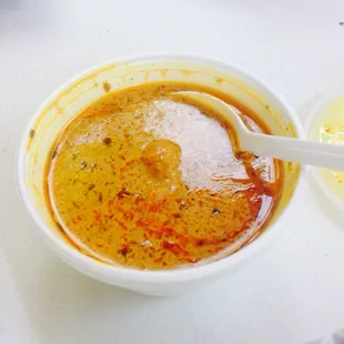 a bowl of soup with a spoon in it