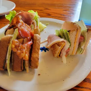 a plate with a cut in half sandwich