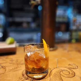 a glass of whiskey on a table