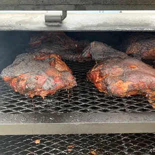 Pork butts smoking on the smoker