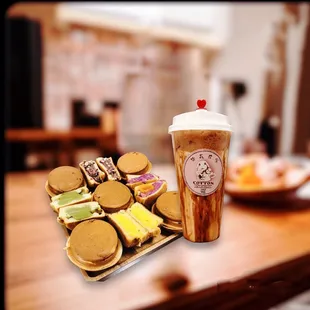 a cup of coffee and a tray of cookies