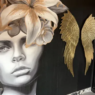 a woman's head with angel wings