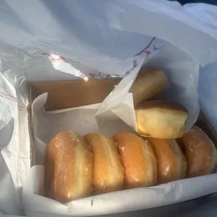 Donuts placed in box that was sitting on a cooler instead of a to go box.