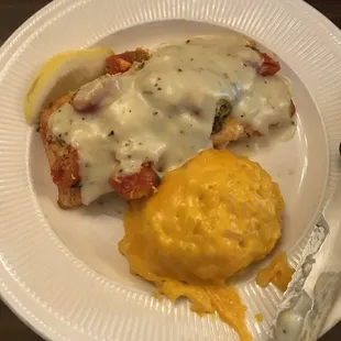 The salmon with roasted tomatoes, spinach and a feta sauce along with cheesy hashbrowns.